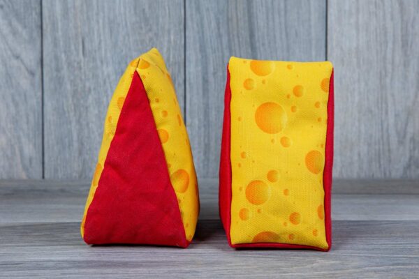 A stuffed toy shaped like a cheese made out of a fabric that looks like cheese