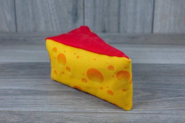 A stuffed toy shaped like a cheese made out of a fabric that looks like cheese