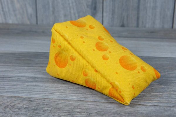 A stuffed toy shaped like a cheese made out of a fabric that looks like cheese