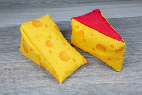 A stuffed toy shaped like a cheese made out of a fabric that looks like cheese