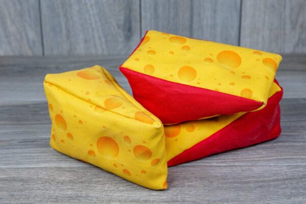 A stuffed toy shaped like a cheese made out of a fabric that looks like cheese