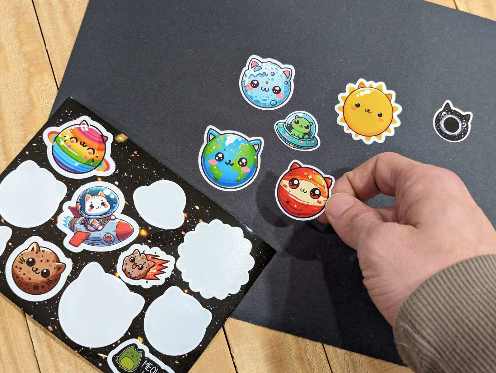 A sheet of stickers of cats that look like planets