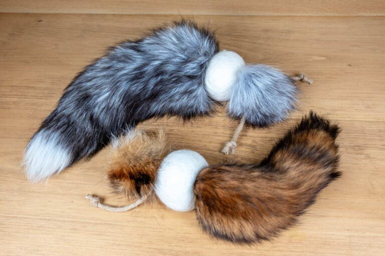 Cat toys made out of a fox tail attached to a wool ball 