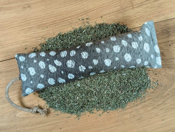 A green catnip filled kicker with white spots.