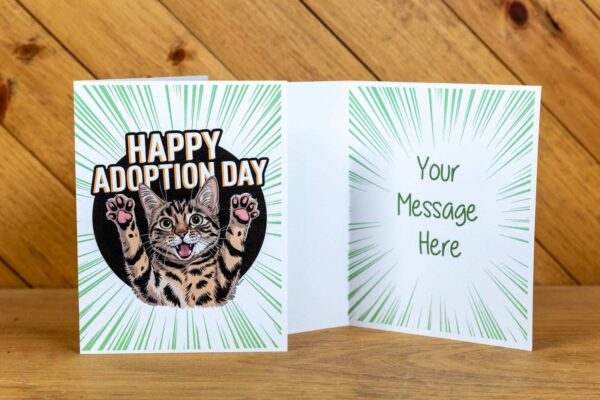 A greeting card with cheering cat with the text Happy Adoption Day