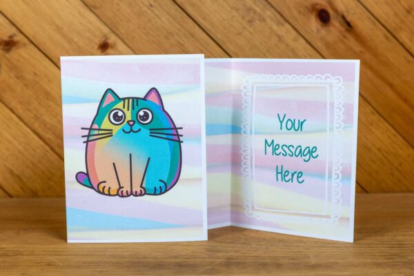A greeting card with a multicolor rainbow cat on the front