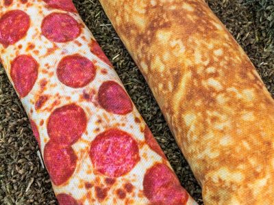 A catnip kicker that looks like pizza with cheese and peperoni on the top half and the crust on the lower half. 