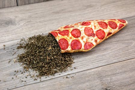 A cat toy sewn from fabric that looks like a realistic pizza slice